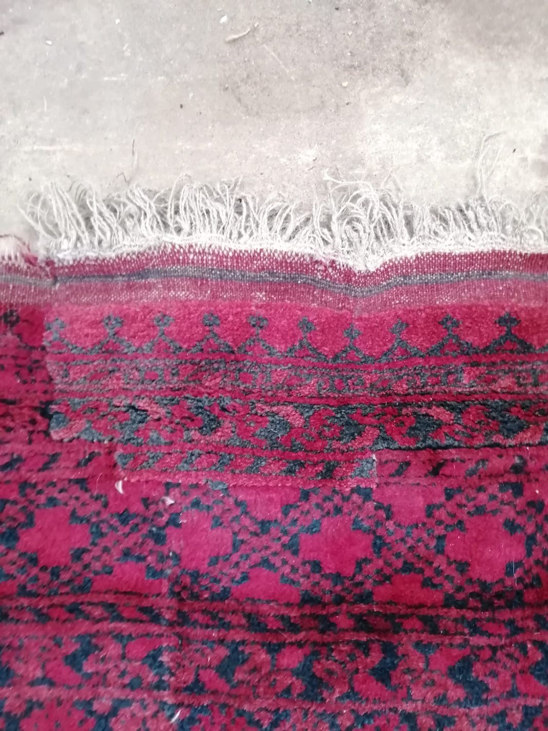 An Afghan red ground carpet (a.f.), 370 x 278cm